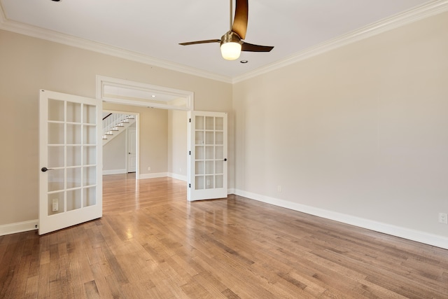 empty room featuring ornamental molding, light hardwood / wood-style floors, ceiling fan, and french doors