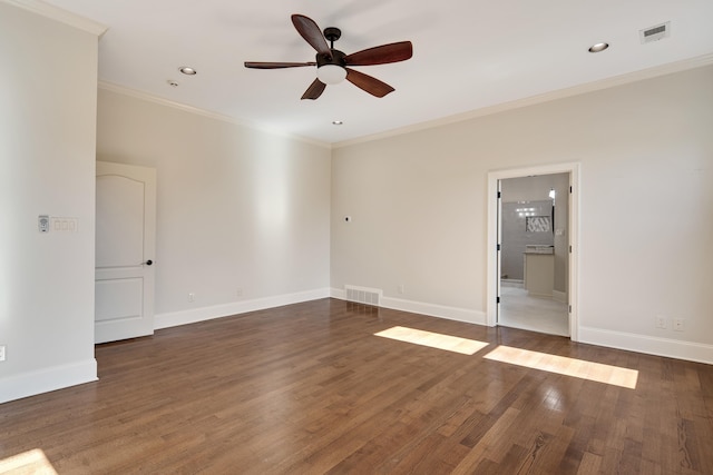 spare room with ceiling fan, ornamental molding, and dark wood-type flooring