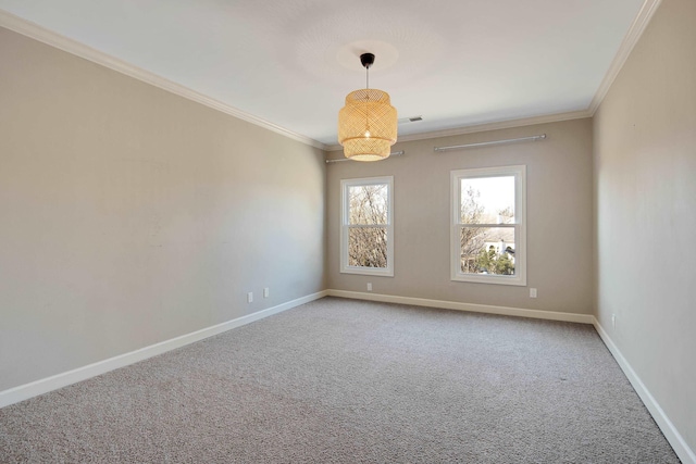 carpeted spare room featuring crown molding