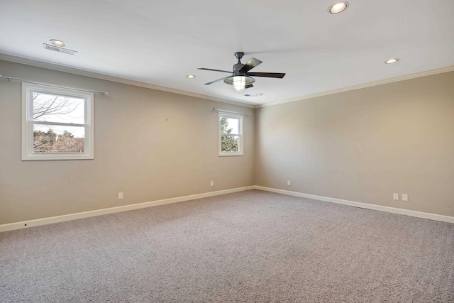 empty room featuring crown molding, carpet flooring, and ceiling fan