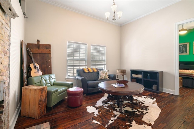 living area with dark hardwood / wood-style flooring, ornamental molding, and an inviting chandelier