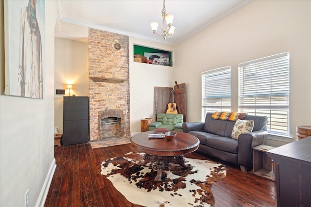 living room with dark wood-type flooring, an inviting chandelier, a brick fireplace, and ornamental molding