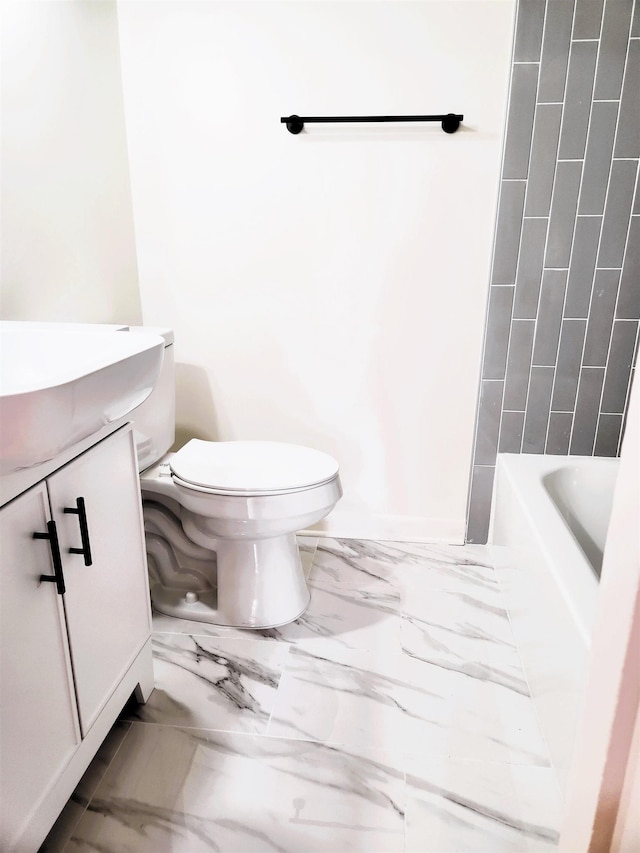 bathroom featuring toilet and vanity