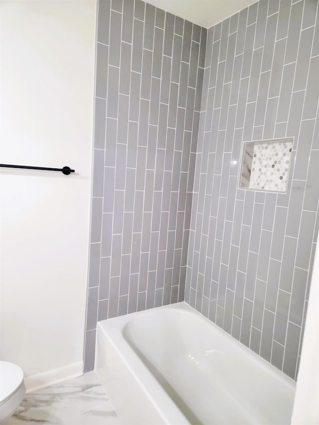 bathroom with shower / washtub combination and toilet