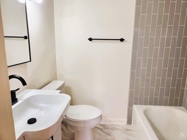 full bathroom featuring sink, toilet, and tiled shower / bath