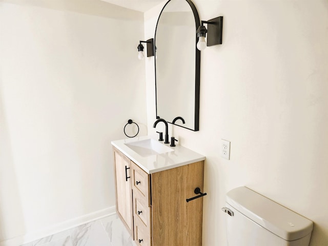 bathroom with toilet and vanity