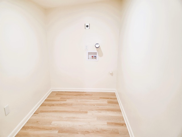 laundry area with wood-type flooring, hookup for an electric dryer, and washer hookup