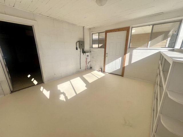 unfurnished room with concrete floors and electric panel