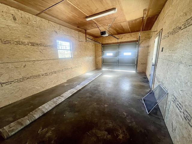 garage featuring wooden ceiling and a garage door opener