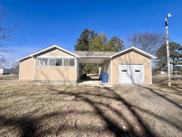 exterior space with a garage and a lawn