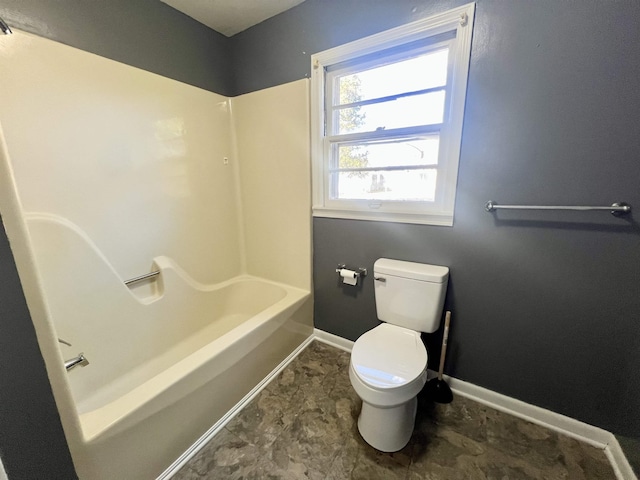 bathroom with toilet and bathing tub / shower combination