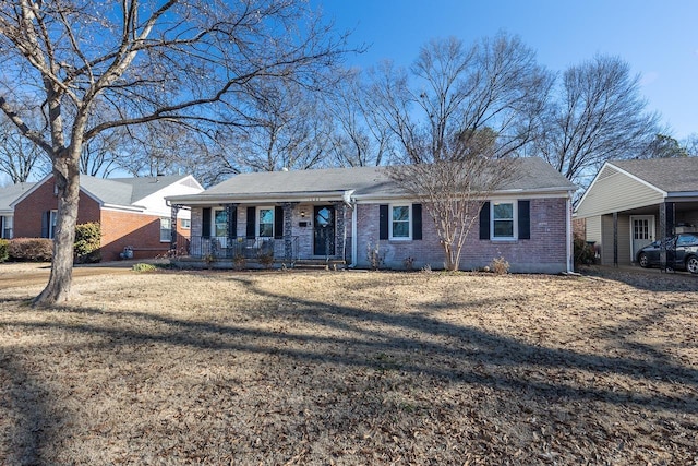 ranch-style house with a front yard and a porch