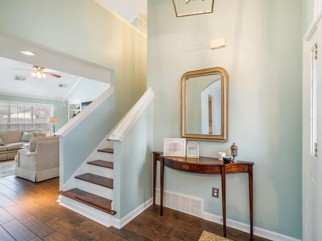 stairs with lofted ceiling, hardwood / wood-style flooring, and ceiling fan