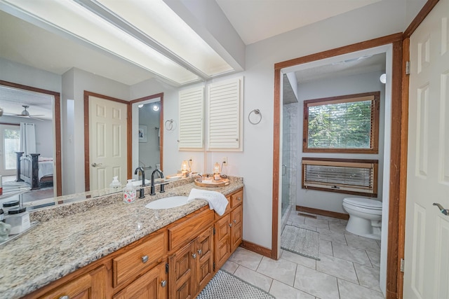 bathroom with a tile shower, toilet, tile patterned floors, and vanity