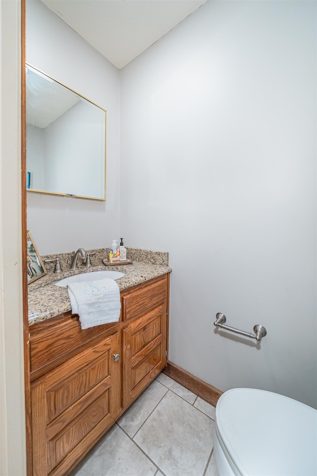 bathroom featuring vanity, toilet, and tile patterned flooring