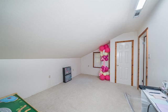 rec room with carpet floors and vaulted ceiling