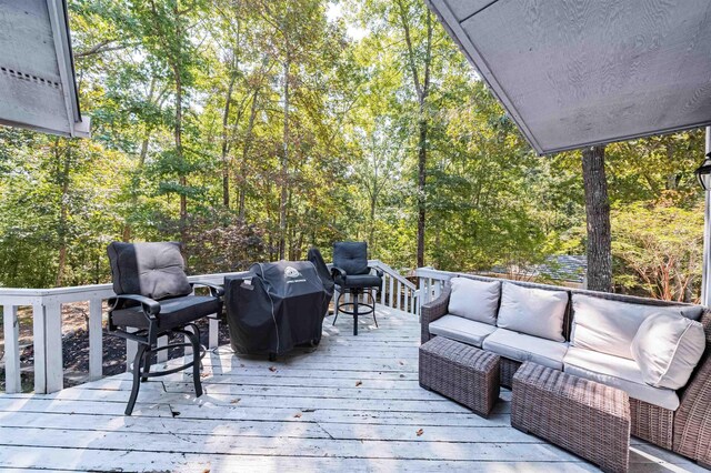 wooden deck with an outdoor living space and grilling area