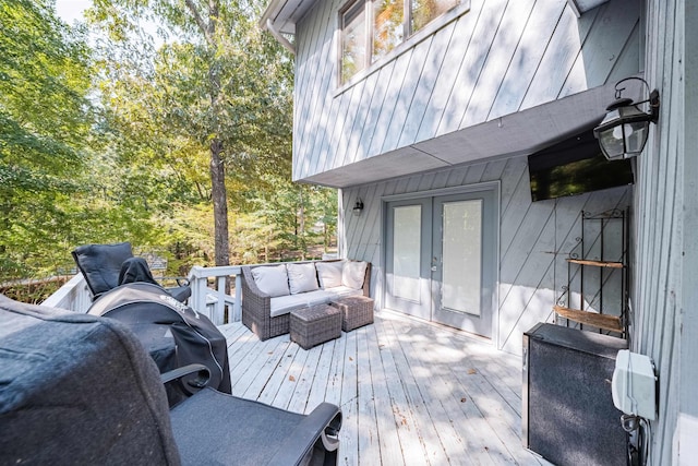 wooden terrace with an outdoor living space