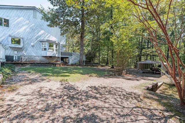 view of yard featuring a carport and central AC