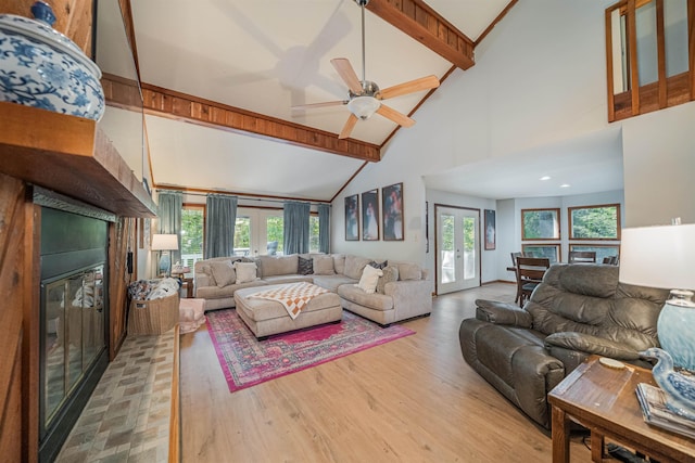 living room featuring french doors, a healthy amount of sunlight, light hardwood / wood-style floors, and high vaulted ceiling