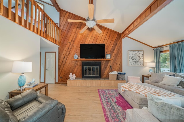 living room featuring hardwood / wood-style flooring, high vaulted ceiling, and ceiling fan