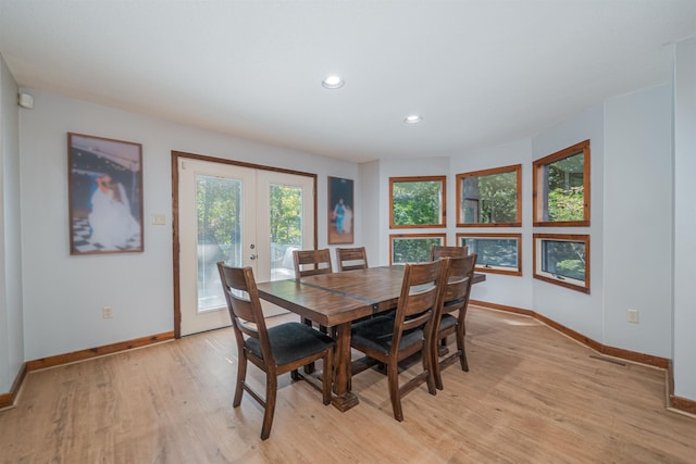 dining space featuring light wood-type flooring and french doors