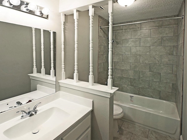 full bathroom featuring a textured ceiling, tiled shower / bath combo, tile patterned flooring, vanity, and toilet