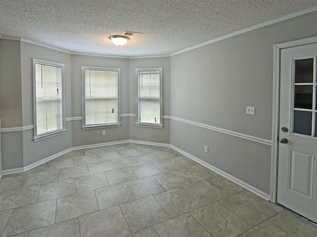 spare room featuring crown molding and a textured ceiling