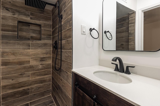 bathroom featuring vanity and tiled shower