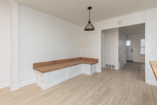 unfurnished dining area with light wood-type flooring