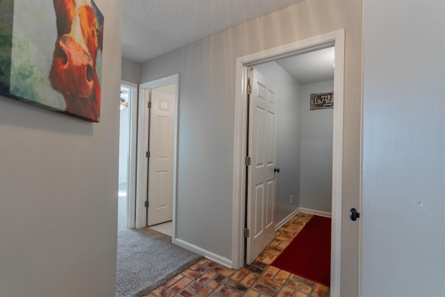 hall with a textured ceiling