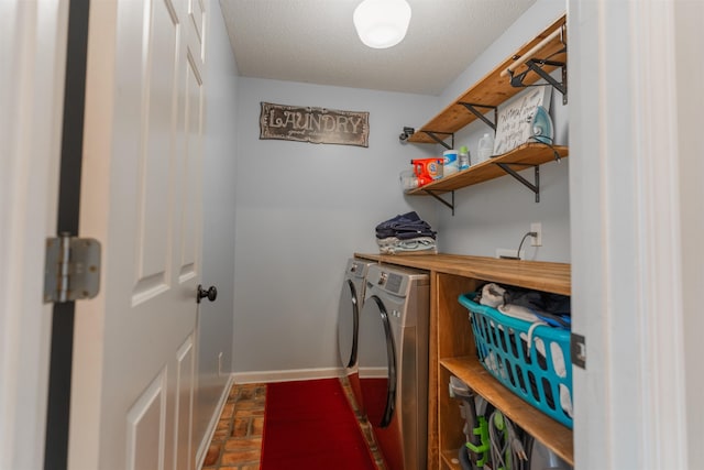 laundry room with bar area, a textured ceiling, and washing machine and dryer