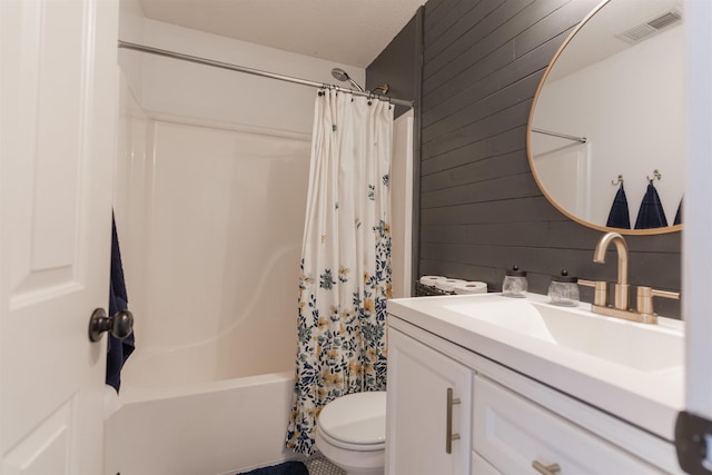 full bathroom with vanity, toilet, wooden walls, and shower / bath combo