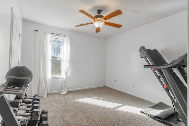 workout area with ceiling fan, a textured ceiling, and carpet floors