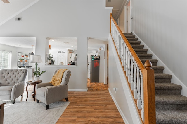 interior space featuring a high ceiling and hardwood / wood-style floors