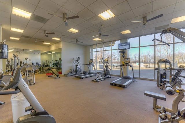 exercise room featuring a wall of windows and ceiling fan