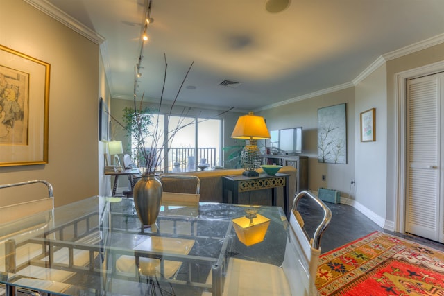 dining room with rail lighting and crown molding