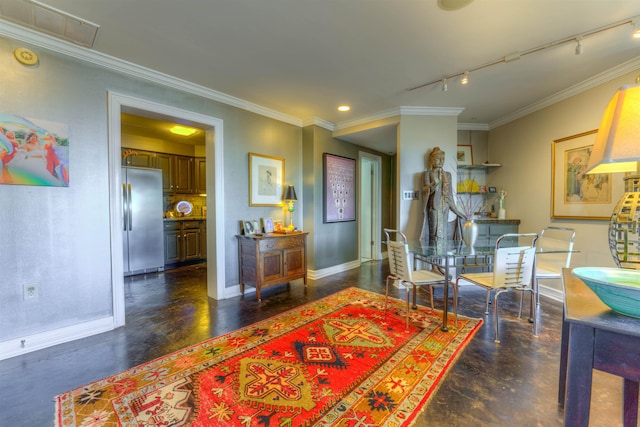 dining space with rail lighting and crown molding