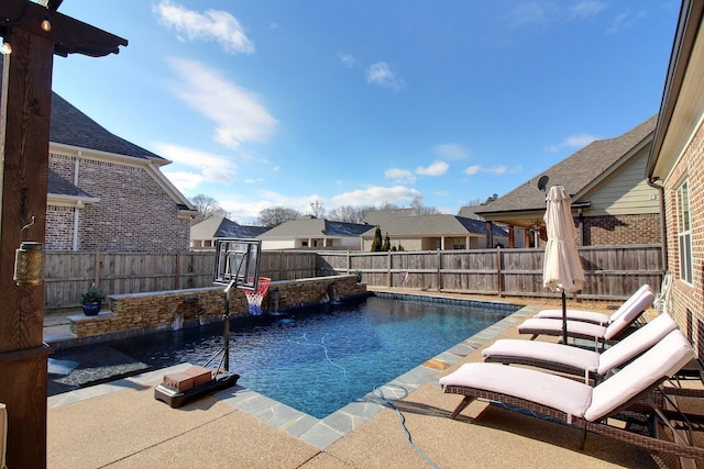 view of swimming pool with pool water feature and a patio