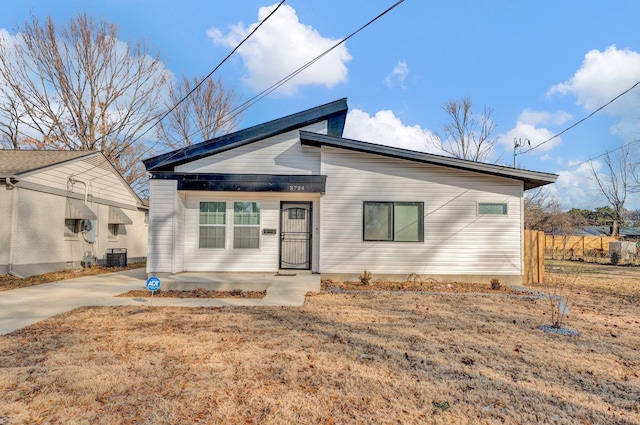 view of front of home featuring a front lawn and central air condition unit