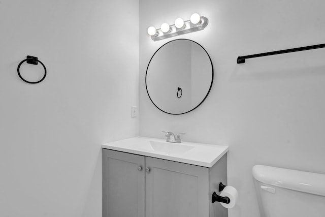 bathroom featuring toilet and vanity