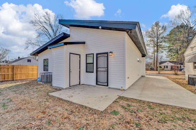 back of house with central AC and a patio