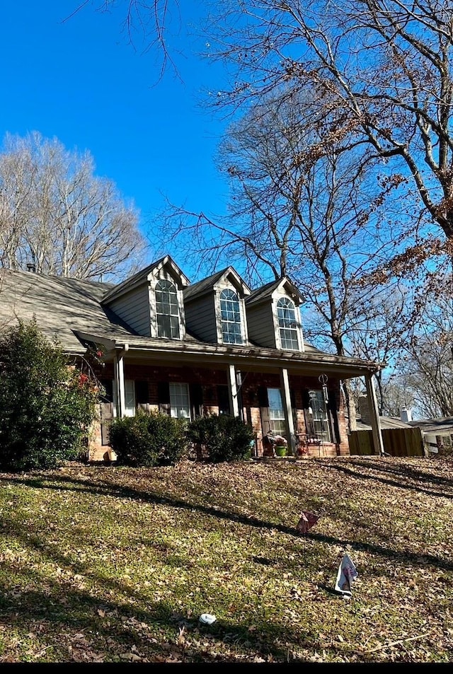 view of front of house featuring a front yard and a porch