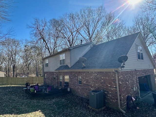 back of house with a deck and central AC unit