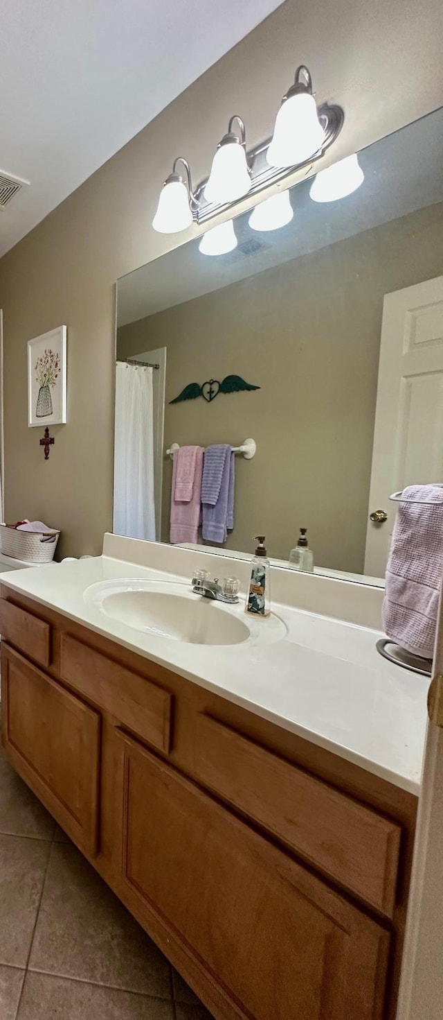 bathroom with a shower with curtain, tile patterned floors, and vanity