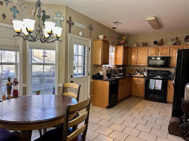 kitchen with hanging light fixtures, sink, light tile patterned floors, black appliances, and an inviting chandelier