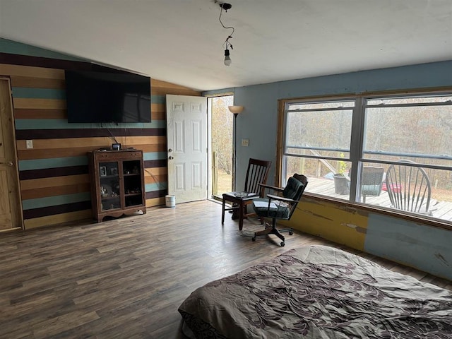 bedroom featuring vaulted ceiling, wood-type flooring, and access to outside