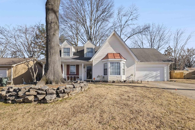 new england style home featuring a garage and a front yard