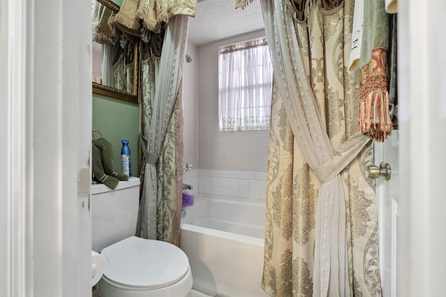 bathroom featuring toilet, a textured ceiling, and shower / tub combo