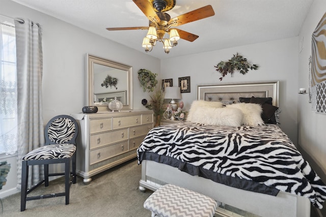 bedroom with ceiling fan and carpet floors